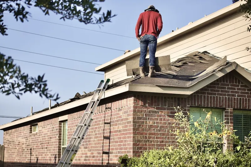 Professional roofer working on a residential roof in Moores Crossroads